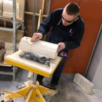 Image showing Sam polishing his stone in the final stages of his project