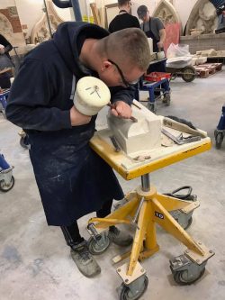 Image showing Sam carving his stone