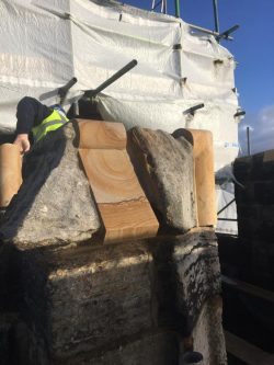 Image showing new carved stone fitted beside existing coping stone