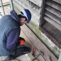 Image showing one of our Lead workers carrying out the lead weathering to the cill of the louvre