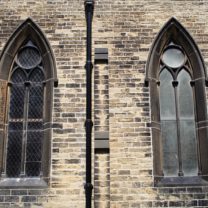 Image of two of the windows at St George, showing the contrast of the new glazing on one window next to the old glass