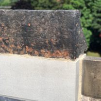 Image showing a newly carved base with an existing coping stone laid on top to make a completed Battlement Stone