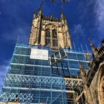 Image of the clock being lifted up the Tower Manchester Cathedral