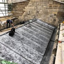 Image showing the new Sandcast Lead being installed to the Chancel roof