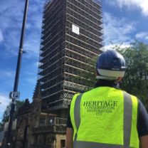 Image showing James one of our company directors looking up at the nearly completed scaffold to the Tower