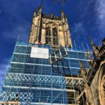 Image showing Clock Face being hoisted up the scaffold ready for installation