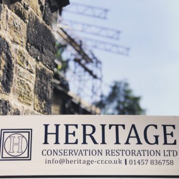 Heritage sign in the foreground, with temporary roof scaffold beiing installed in the background